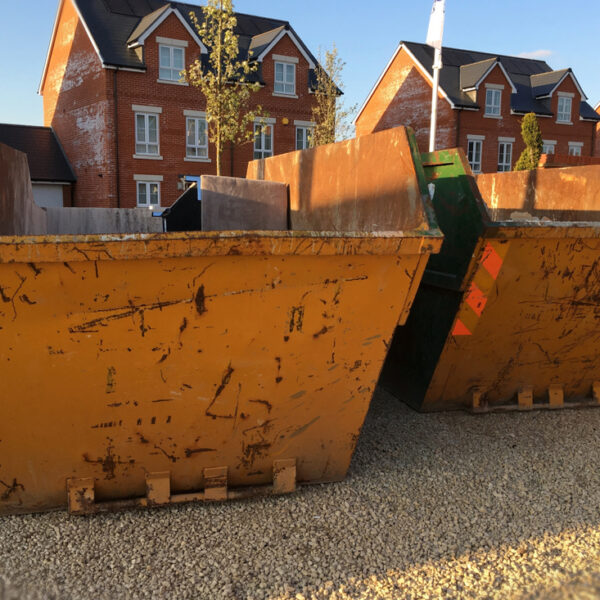 two yellow skips from Newport Skip Hire being used for domestic waste clearance