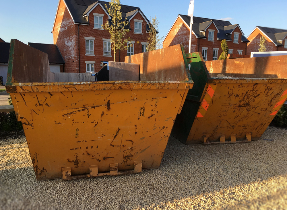 two yellow skips from Newport Skip Hire being used for domestic waste clearance